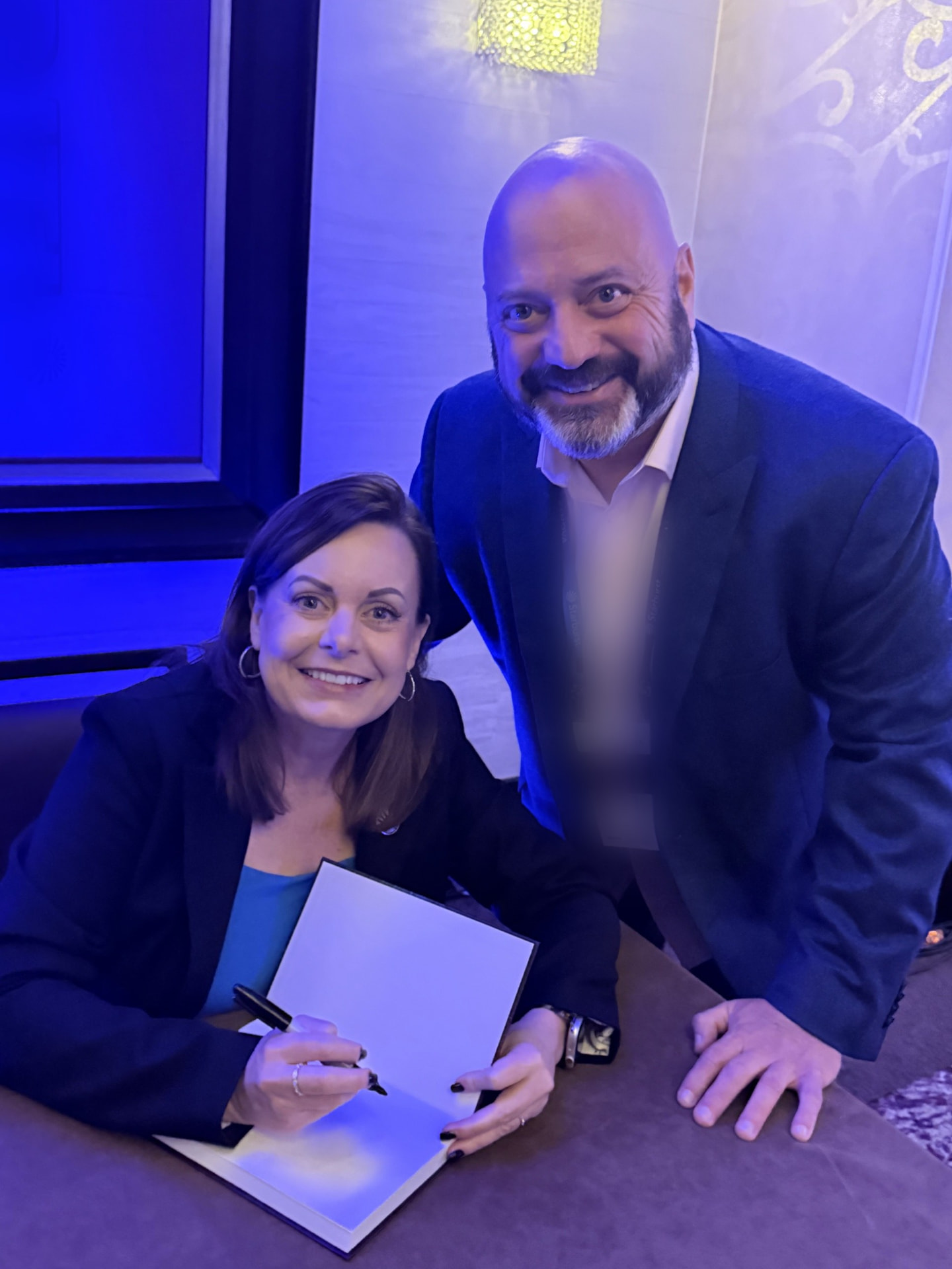Dr. Lisa Palmer signing a copy of Show AI—Don't Tell It